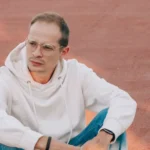 Young man exploring colorful streets of a bustling exotic city